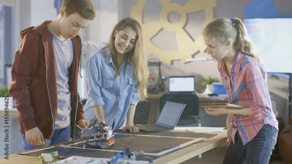 Poster two girls and a boy program self driving robot for school science class project. shot on red epic-w 