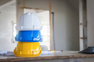 The safety helmet and the blueprint on table at construction site