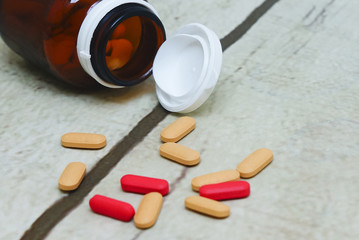 medicine bottle falls on the floor and spilled out capsule