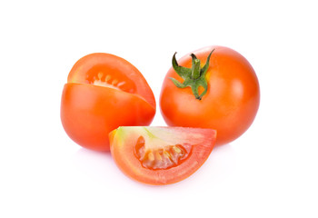 whole and portion cut fresh tomato on white background