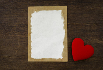 Blank old paper card and red heart on vintage wood background, valentine card concept