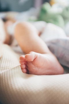 Soft Focus and Abstract image of baby foot at home. A newborn baby as blurred background.