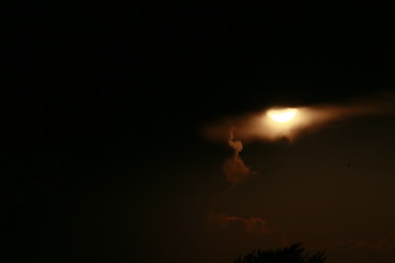 Sun peeking from behind thunderclouds in Indiana during on a spring day. 