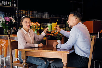 A man and a woman in a cafe.