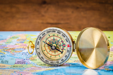 Compass on world map.