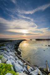 beautiful estuary of the sky during sunset with a fishing boat unclear