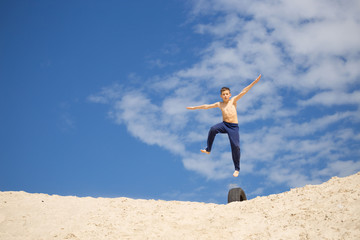GOMEL, BELARUS - May 13, 2017: Teens study parkour on their own. Acrobatics in the sand.