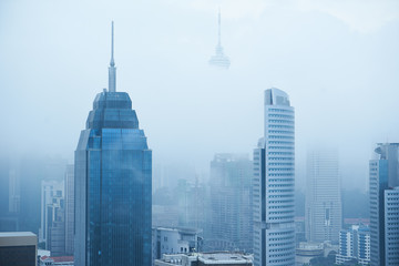 Obraz premium Top view of foggy Kuala Lumpur city skyline in the morning .