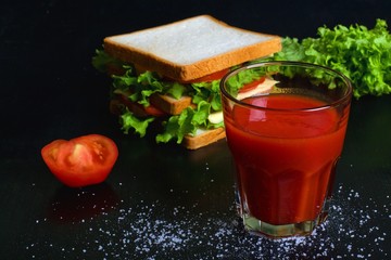 Fresh tomato juice on a dark background