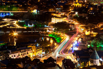 Night panorama view of Tbilisi, capital of Georgia country. Meidani square at night with illumination and moving cars.