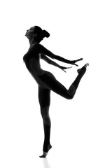 Free and healthy. Silhouette of a elegant fit female gymnast posing gracefully