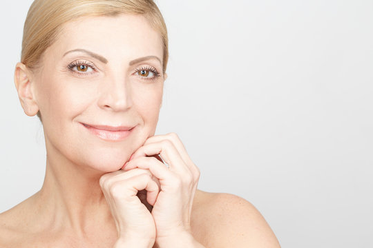 Beautiful wisdom. Cropped closeup of an attractive mid adult woman posing in studio smiling softly copyspace on the side
