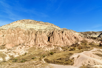 Fototapeta na wymiar View of cave houses in valley at Cavusin. Cappadocia. Turkey