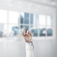 Choosing gesture of businessperson in elegant modern interior in