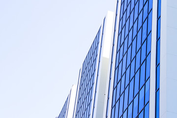 Fototapeta na wymiar Blue sky reflected on blue building side