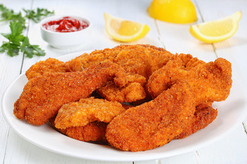 homemade chicken nuggets on white plate