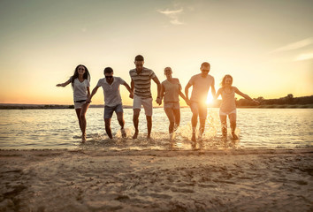 Silhouette of group young people on the beach.