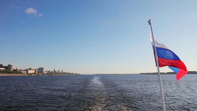 The Russian flag waving at the stern of the passenger ship traveling on the Volga river. Full HD stock footage shot at summer season time.
