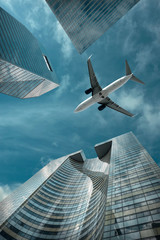 Airlane flying over modern glass and steel office buildings near