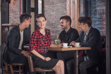 coffee shop table, small group of people talking, sitting in bar stool, woman looking to the camera
