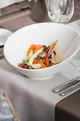 delicious salmon salad in a restaurant. small portion