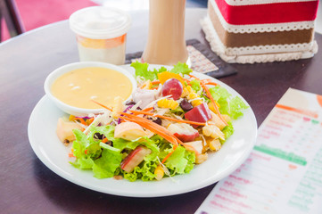 salad with dressing on dish.