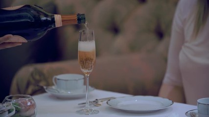 Closeup of waiter pouring pink champagne - Powered by Adobe
