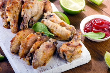 Chicken wings with celery on wooden table