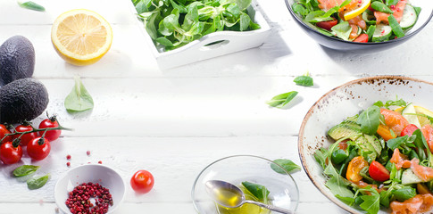 Fresh Salmon salad on a white wooden table. Healthy eating.