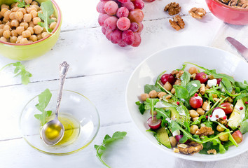 Healthy salad with chickpea, grape, walnut  and avocado.