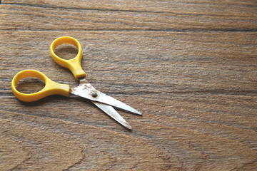 old rusty scissors isolated on wooden background.