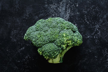 Broccoli on dark stone slate background. Top view