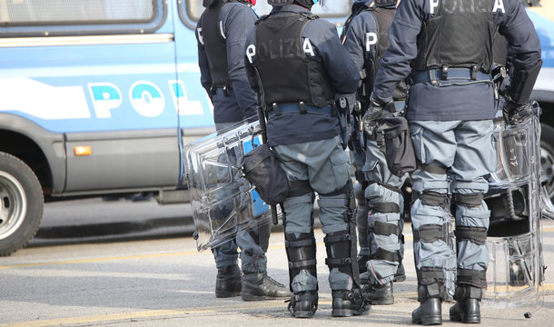Italian anti-riot policemen with protective helmet control the city