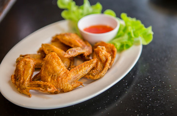Fried chicken wings on white dish, Thai food