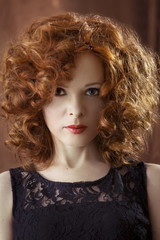 Fototapeta premium Portrait of beautiful woman with long curly red. Display languag