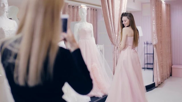 girl chooses a prom dress in shop