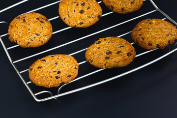 Fresh baked Chocolate chip and hazel nut cookies on black slate plate