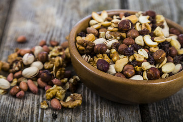 Nuts in a wooden bowl  on a  wooden table.