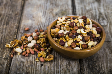 Nuts in a wooden bowl  on a  wooden table.