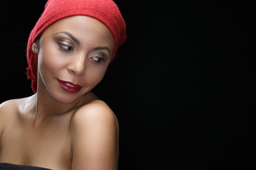 Beauty and tradition. Studio shot of a beautiful African woman wearing headscarf looking to the side smiling copyspace on the side