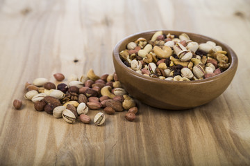 Nuts in a wooden bowl  on a  wooden table.