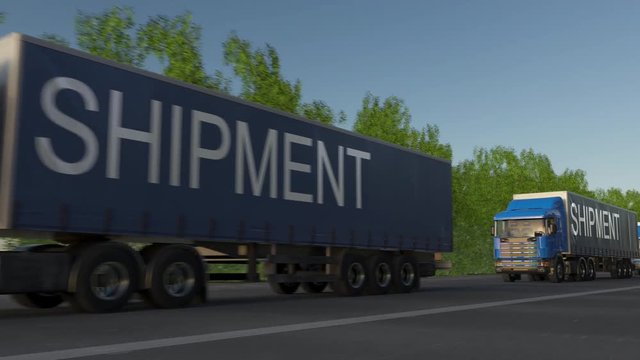 Speeding freight semi trucks with SHIPMENT caption on the trailer. Road cargo transportation. Seamless loop 4K clip