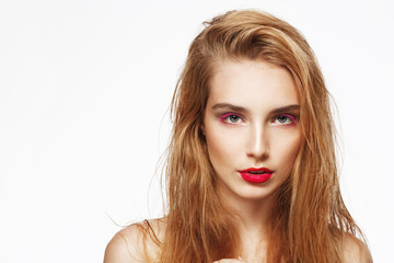 Close-up portrait of young beautiful confident thoughtful girl with bright make up. White background. Isolated.