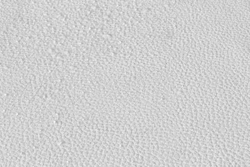 Light gray leather pad with water drops spread throughout the sheet