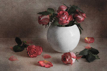 Still life of red roses in a white vase. An artistic image.