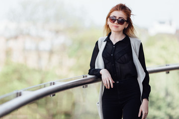 One girl pose to camera near the wall with sunlight