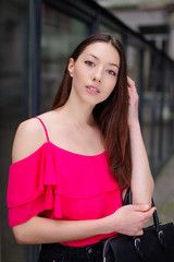 One girl pose to camera near the wall