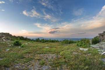 Sunset over the mountainous terrain. The nature of the Southern Urals. Sunset sky over the forest.