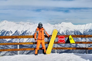 Man stands on backgroung of Krasnaya Polyana mountain resort