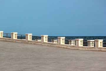 Empty coastal embankment with marble balustrade and sea horizon